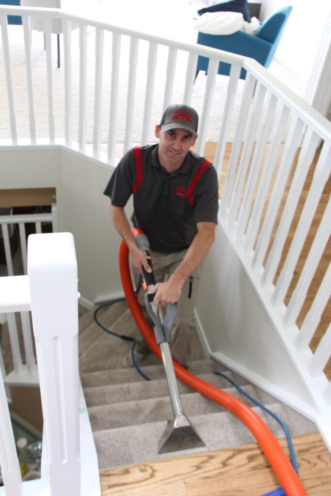 Man steam cleaning stairs