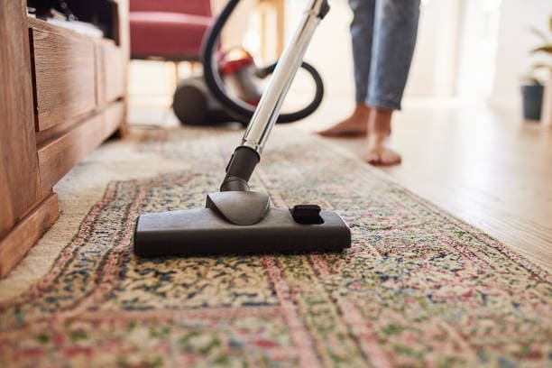 woman vacuuming a rug
